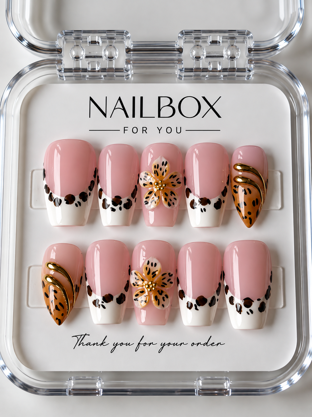 Olive Bloom blush pink press-on nails with white French tips, leopard-print borders, raised amber flowers and gold curves.