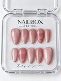 Rosé Shimmer rose pink press-on nails with fine shimmer, delicate glitter tips, and pink marble accent nails with pale flowing veins, displayed in a clear nail box.