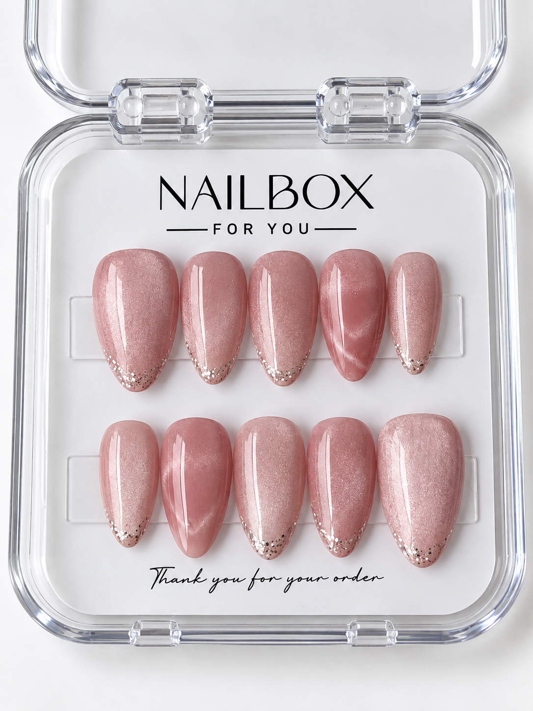 Rosé Shimmer rose pink press-on nails with fine shimmer, delicate glitter tips, and pink marble accent nails with pale flowing veins, displayed in a clear nail box.