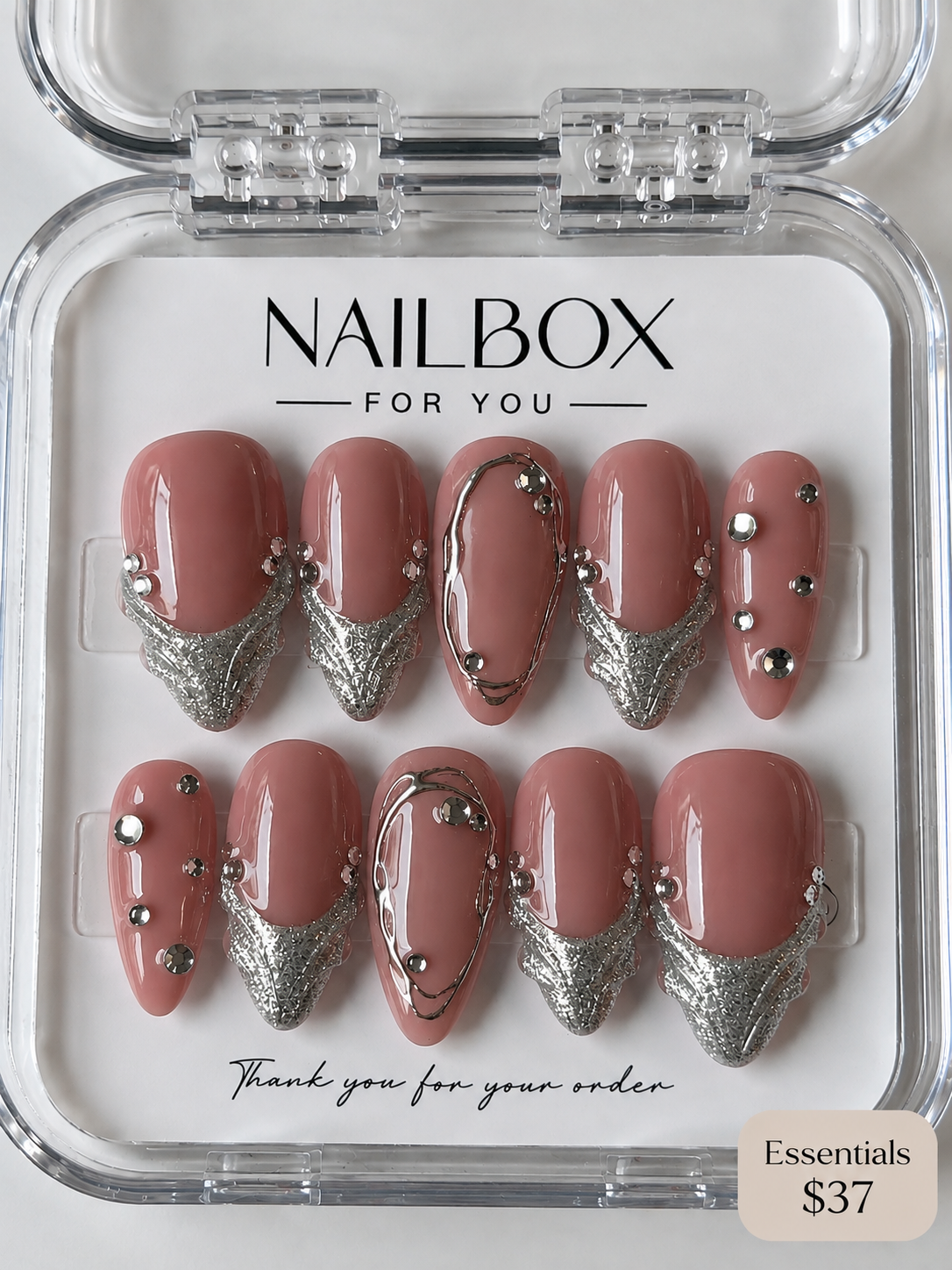 Silver Kiss dusty pink press-on nails with textured silver French tips, flowing metallic outlines and sparkling gems.