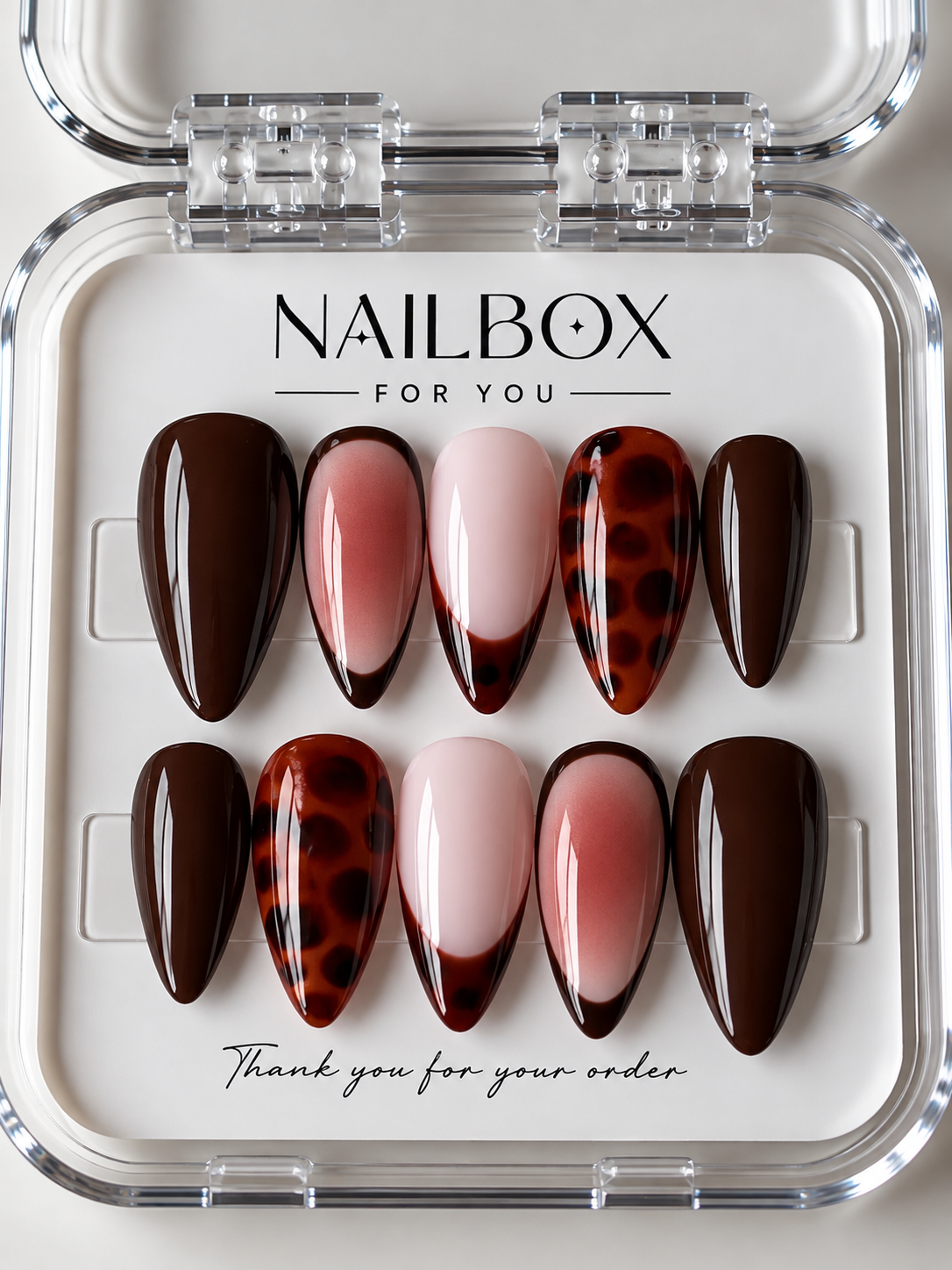 Wild Romance press-on nails with glossy chocolate brown, blush pink shimmer, amber tortoiseshell patterns and French tips.