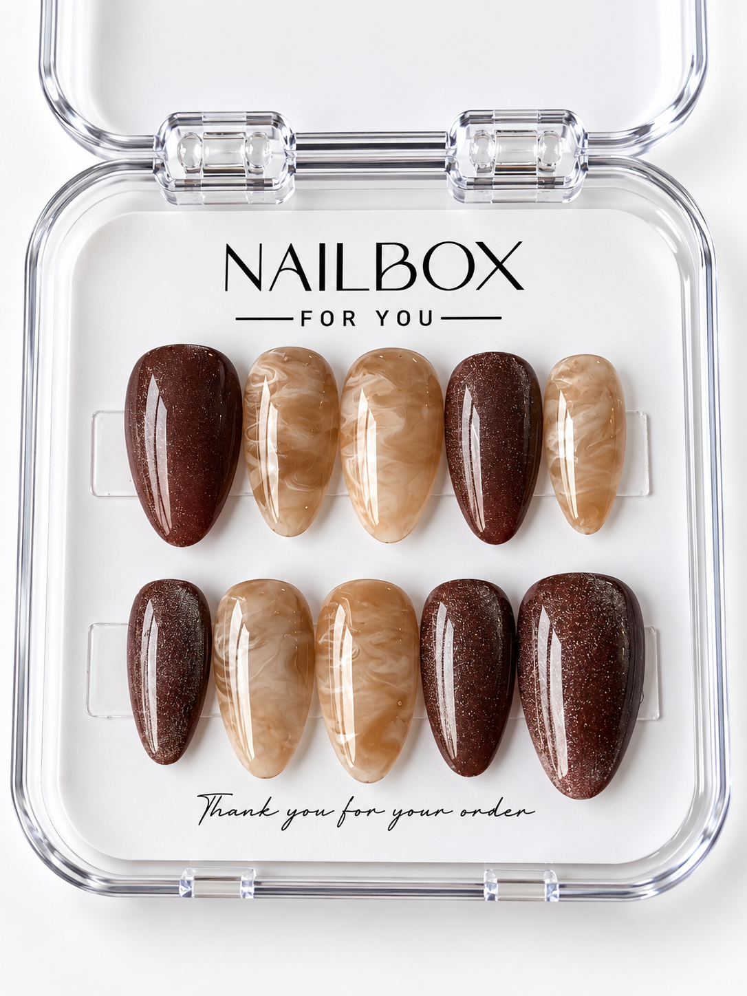 Caramel Latte press-on nails with glossy chocolate brown shimmer and caramel marble swirls with ivory veining, displayed in a clear nail box.